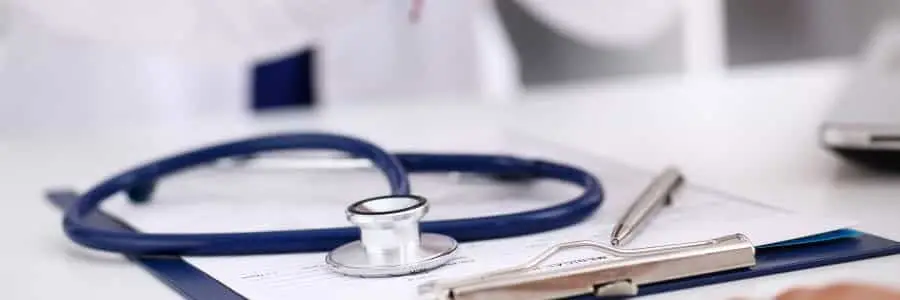 Stethoscope and clipboard on doctor's desk